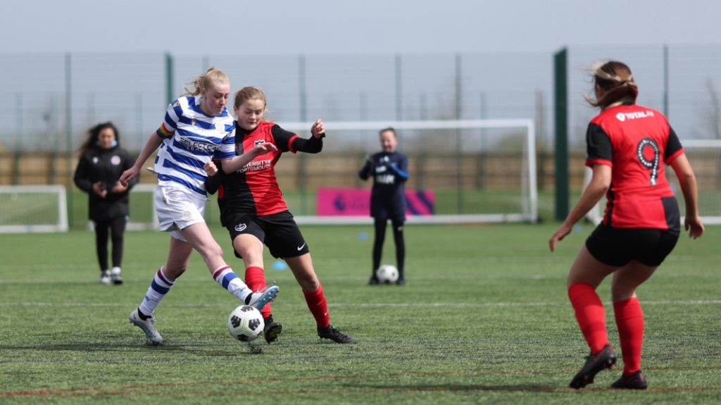 Annalea Lane kicks the ball forward for Reading FC Women during a match.